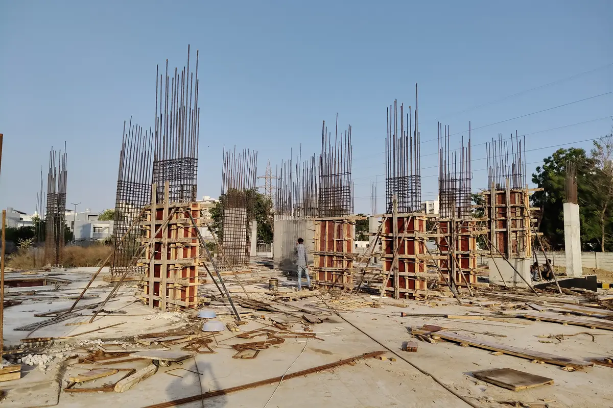 Column reinforcement cages standing on the cast basement raft at Vasantara Skies, Chhani