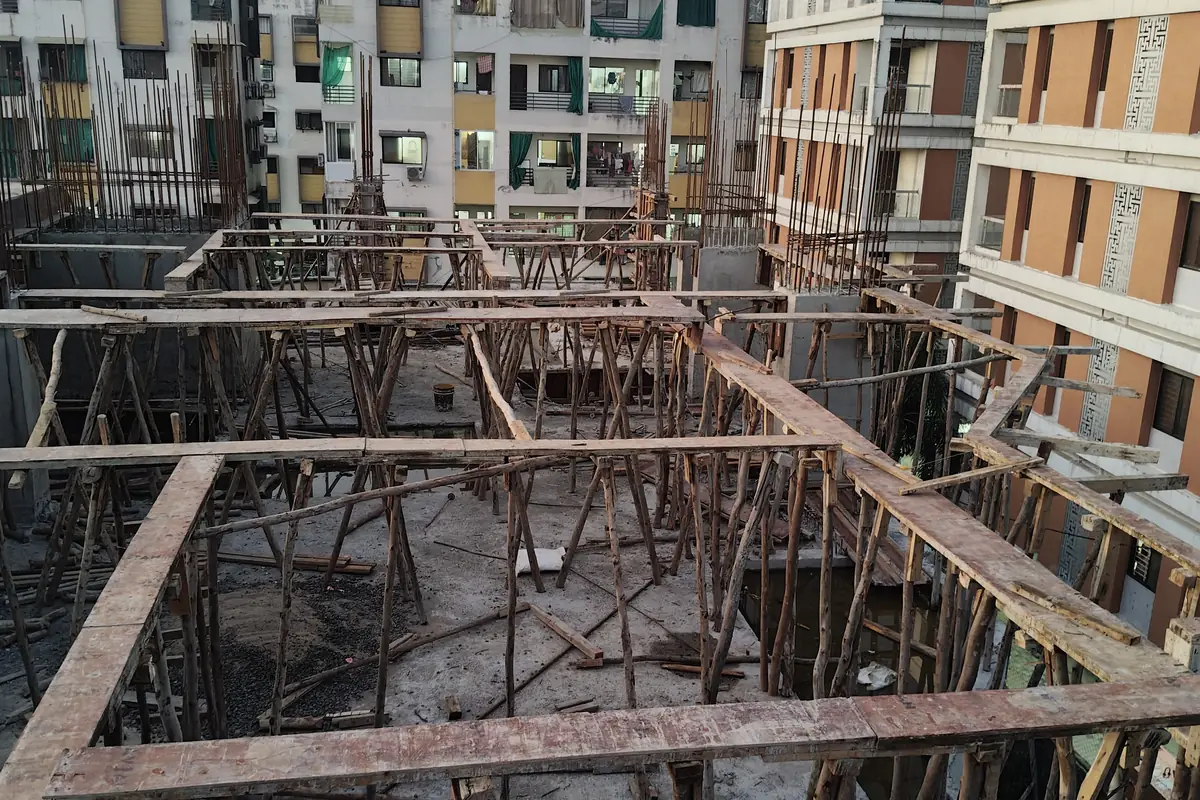 Reinforcement laid for the second floor slab at Vasantara Skies, neighbouring buildings behind